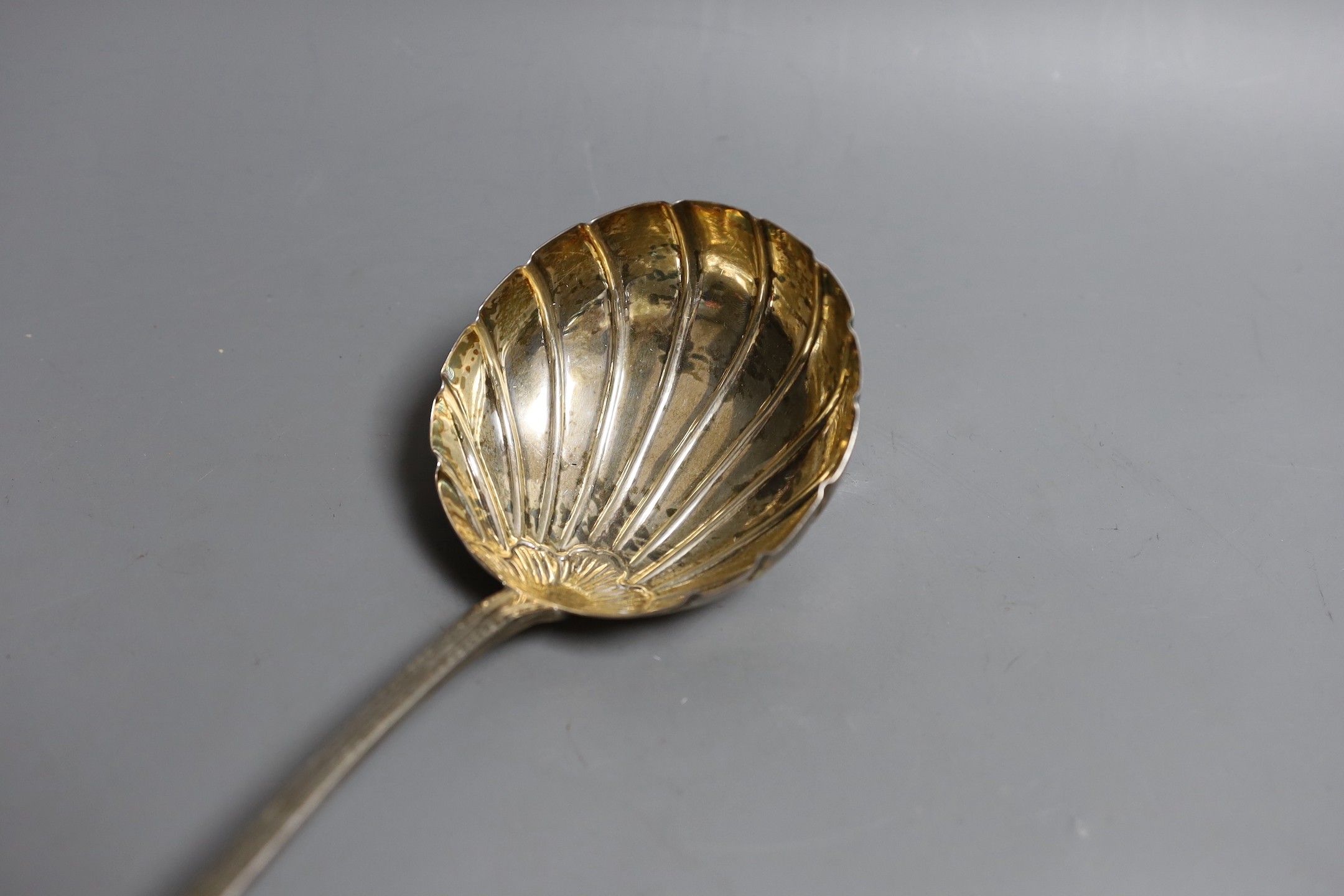 A George IV Irish engraved silver soup ladle, with fluted bowl, Charles Marsh, Dublin, 1826, 34.6cm, 187 grams.